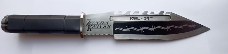 May include: A silver and black knife with a black handle and a serrated blade. The blade has a barbed wire design and the text "RWL - 34" and "ZUNDA KNIVES" is engraved on the blade.