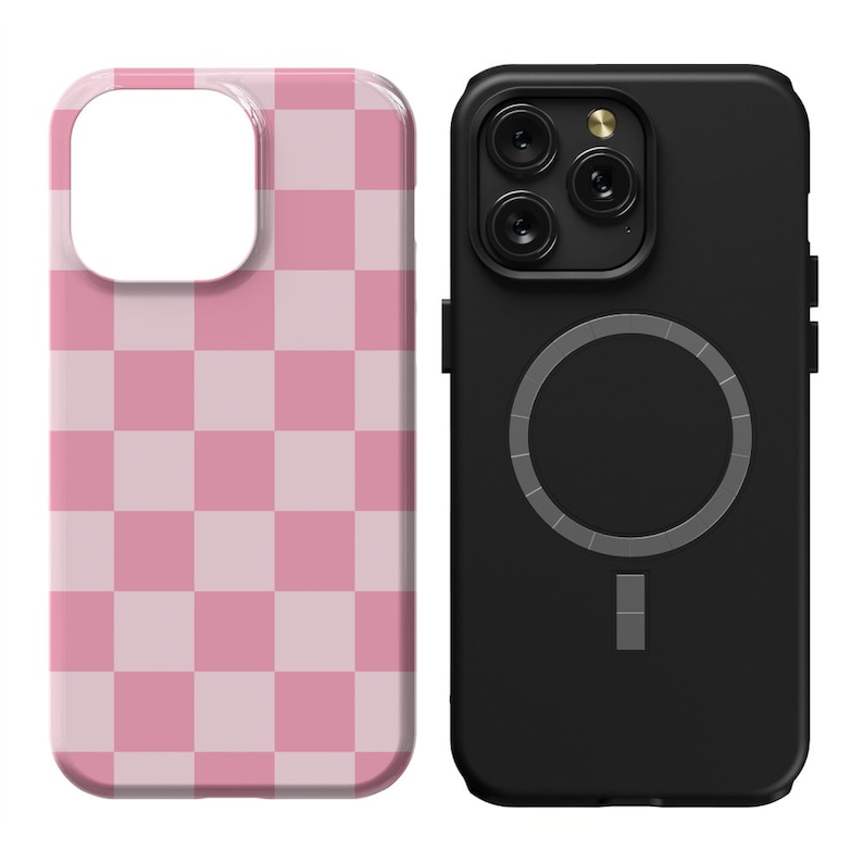 May include: Two phone cases, one black with a circular magnetic charging pad and the other pink with a checkered pattern.