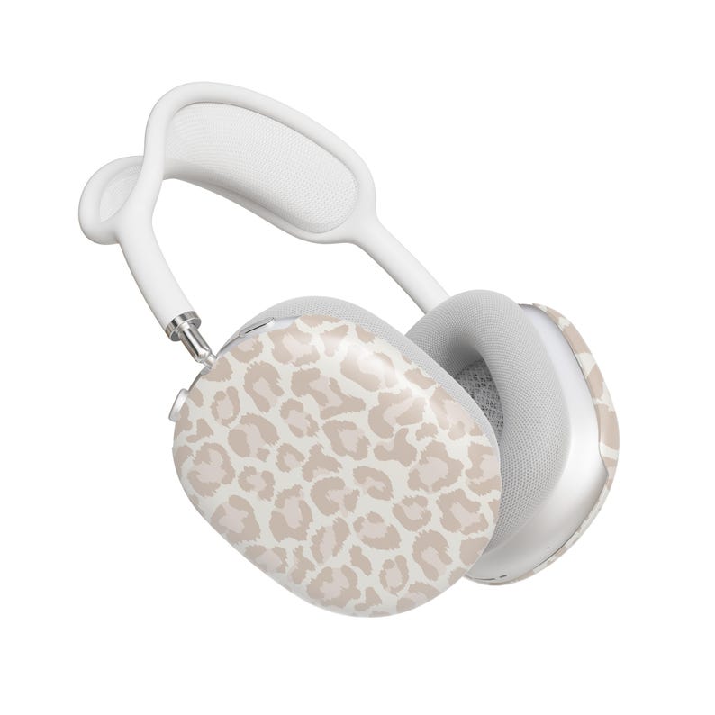 May include: White wireless headphones with a beige leopard print design on one earcup.