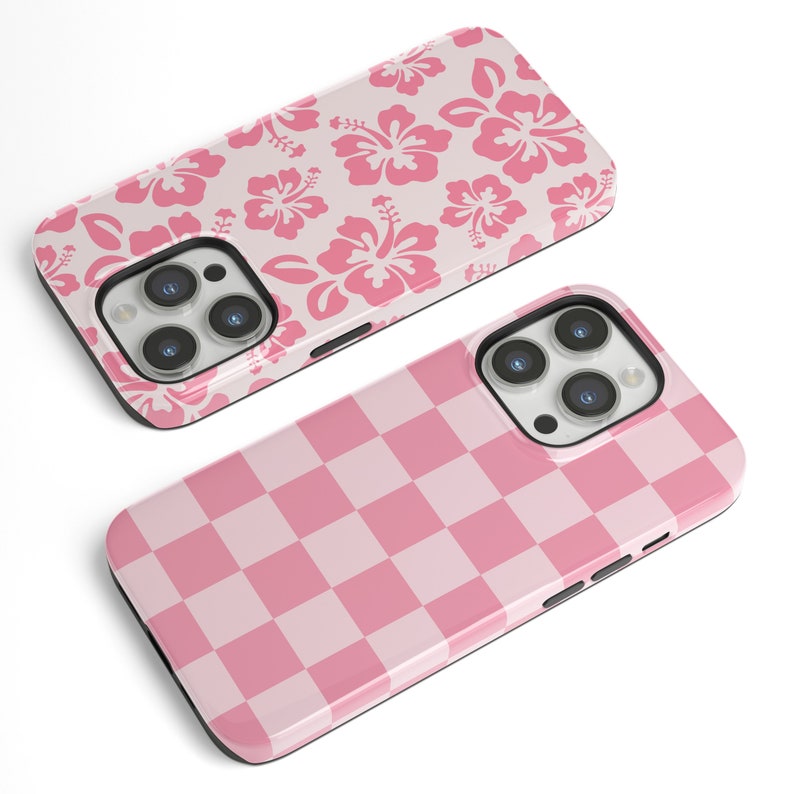 May include: Two pink iPhone cases. One case has a pink floral pattern. The other case has a pink and white checkered pattern.
