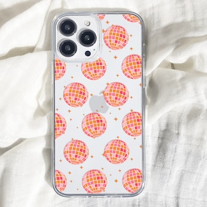 May include: A clear phone case with a white background and a repeating pattern of pink and orange disco balls.