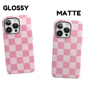 May include: Two iPhone cases with a pink and white checkered pattern. The case on the left is glossy and the case on the right is matte.