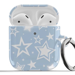 May include: A light blue Airpods case with a white star pattern and a silver metal ring attached.