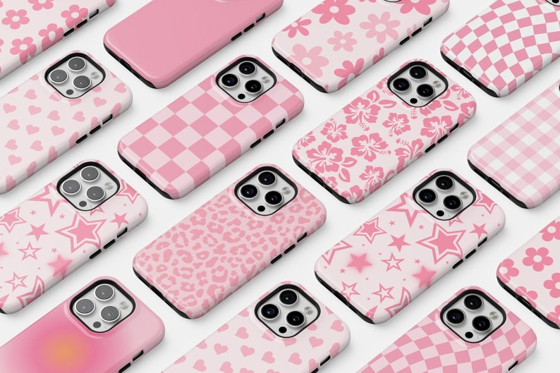 May include: A collection of pink iPhone cases with various patterns, including hearts, stars, flowers, and checkered designs.