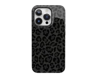 May include: A black and gray leopard print phone case. The case has a glossy finish and a rounded shape. The camera lenses are visible at the top. The leopard print pattern covers the entire back of the case.