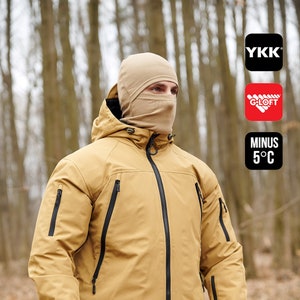 May include: Tan hooded jacket with black zippers and a matching balaclava. The jacket has multiple pockets and is worn with camouflage gloves. The image includes the text "MINUS 5°C".