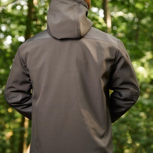 May include: A black hooded jacket with a zipper closure and a brown fleece lining around the hood.