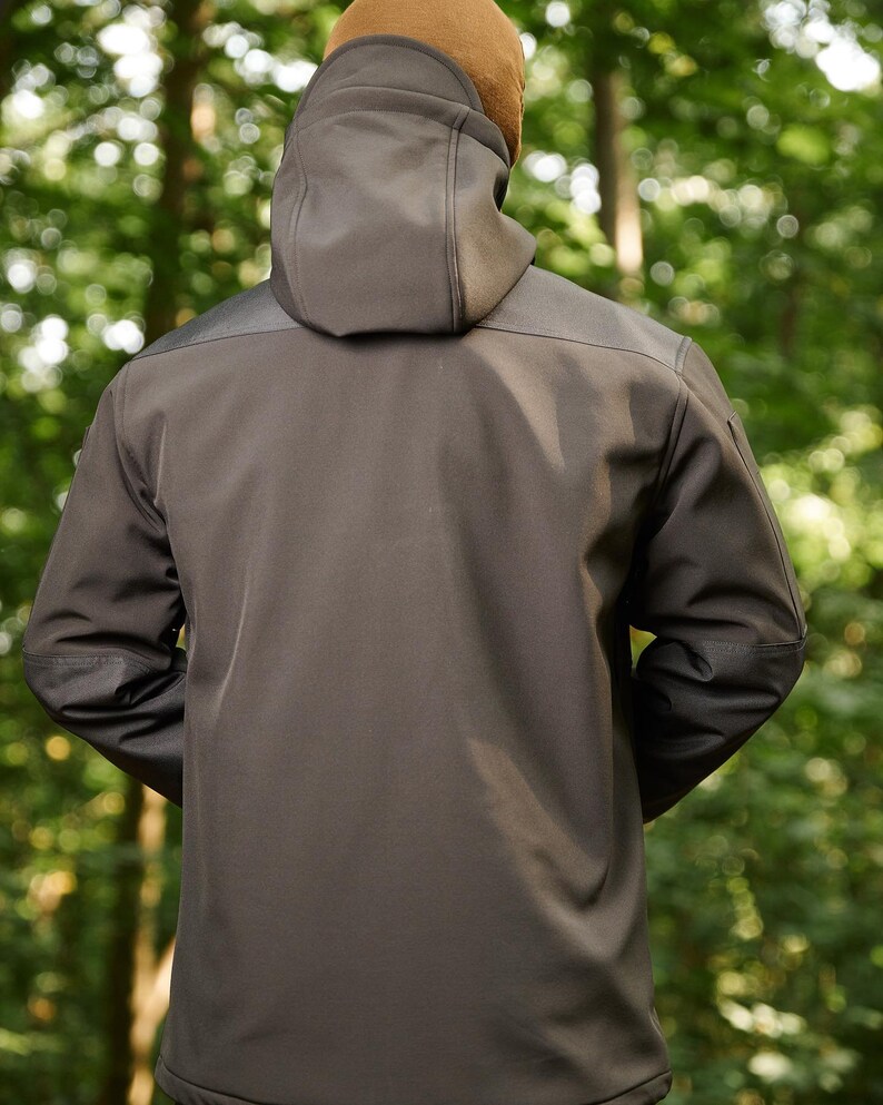 May include: A black hooded jacket with a zipper closure and a brown fleece lining around the hood.