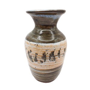 May include: A ceramic vase with a flared rim, featuring a glossy dark brown glaze on the neck and base. The midsection displays a textured, light beige band with horizontal ridges and irregular dark brown vertical brushstroke patterns throughout.