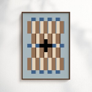 May include: A framed wall art print featuring a geometric pattern of vertical brown and beige stripes on a light blue background. A solid black cross shape is centered in the middle, accented by small blue squares along the top and bottom edges.
