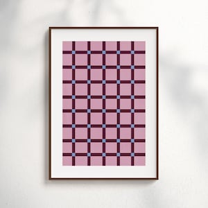 May include: Framed print featuring a geometric pattern. The design consists of a grid of pink squares, intersected by dark burgundy lines and small blue squares at the intersections. The frame is a dark brown color.