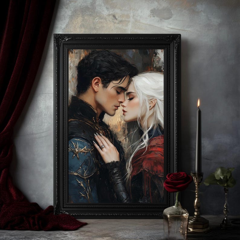 May include: A framed artwork depicts a romantic scene of a couple embracing. The man has dark hair and wears a blue and black jacket. The woman has white hair and a red cloak. The artwork is in a black frame, with a candle and rose in the foreground.