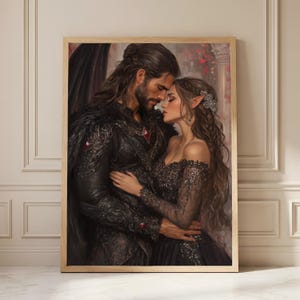 May include: A framed wall art print depicting a dark-haired man with a beard and a woman with pointed ears in an embrace. The man wears black ornate armor with red accents and a dark cape. The woman wears a black off-the-shoulder lace gown.
