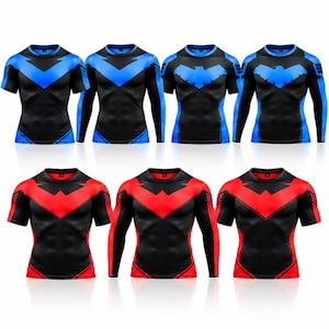 May include: A collection of seven compression shirts in black with blue or red accents. The shirts feature a chevron pattern across the chest and shoulders, available in both short-sleeve and long-sleeve styles with a crew neckline.
