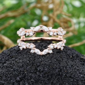 Op de afbeelding: Roze gouden ring met een marquise- en ronde diamantbezetting. De ring is ontworpen om te worden gedragen als trouwring of als verlovingsring.