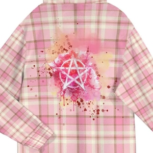 May include: Pink plaid long-sleeved shirt with a high collar. The back features a white pentagram design over a watercolour splash of pink, orange, and red. The shirt has a classic plaid pattern in shades of pink and beige.