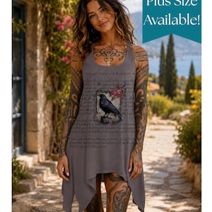 May include: A sleeveless grey tank dress featuring a graphic of a black raven perched on a branch with red flowers, surrounded by cursive script text. The hemline is asymmetrical with pointed edges. The text Plus Size Available is visible.