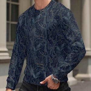 May include: A long-sleeve crew neck shirt in a dark navy blue colour featuring an all-over pattern of silhouetted birds perched within a dense network of intertwined tree branches and foliage, creating a detailed and repetitive nature-inspired design.