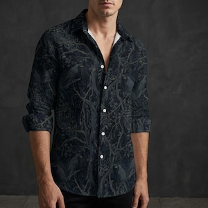 May include: A long-sleeve button-down shirt featuring a dark, moody forest pattern with silhouettes of birds perched on branches. The shirt has a classic collar, a white inner placket, and a repeating print of trees and foliage in shades of black and gray.