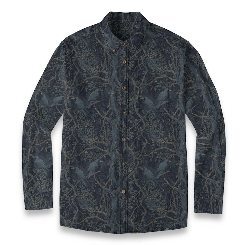 May include: A long-sleeve button-down shirt in a dark navy blue color featuring an all-over print of black birds perched on tangled tree branches with leaves. The shirt includes a front chest pocket, a pointed collar, and light brown buttons.