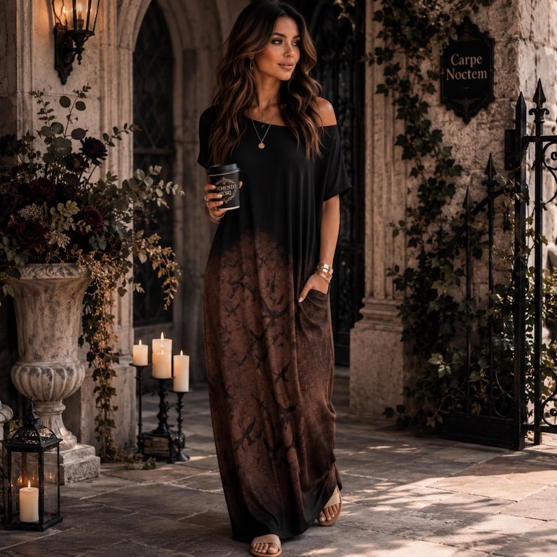 May include: A black and brown ombre maxi dress with short sleeves, a round neckline, and side pockets. The dress features a dark, mottled pattern that transitions from solid black at the top to a textured, earthy brown tone toward the hemline.