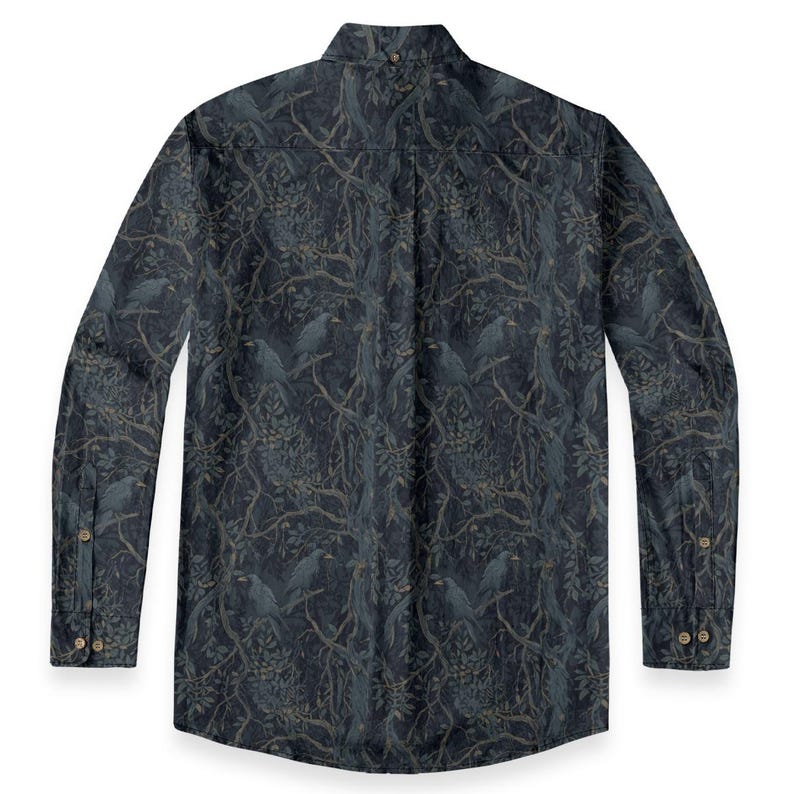 May include: A long-sleeve button-down shirt in a dark navy blue color featuring an all-over print of black birds perched on tangled tree branches with leaves. The shirt has a pointed collar, a buttoned placket, and buttoned cuffs on the sleeves.
