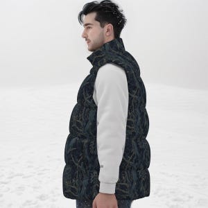 May include: A sleeveless puffer vest featuring a dark navy blue base with a repeating pattern of brown tree branches and foliage. The vest has a high collar and a quilted construction, worn over a plain white long-sleeved shirt.