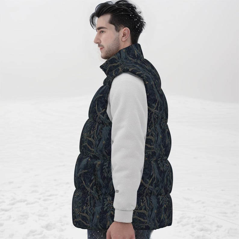 May include: A sleeveless puffer vest featuring a dark navy blue base with a repeating pattern of brown tree branches and foliage. The vest has a high collar and a quilted construction, worn over a plain white long-sleeved shirt.