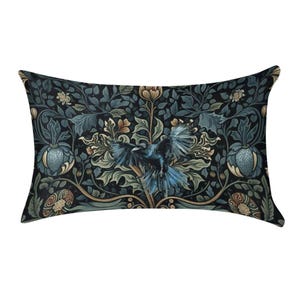 May include: A rectangular throw pillow featuring a dark, intricate botanical pattern with deep blue, green, and muted gold tones. A central black bird with spread wings is surrounded by stylized foliage, leaves, and floral elements.