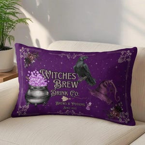 May include: A rectangular purple throw pillow featuring a black cauldron filled with glowing light purple bubbles, a black raven, and a purple witch hat. The text reads Witches Brew Drink Co. Brews & Potions Since 1692, framed by ornate floral corners.