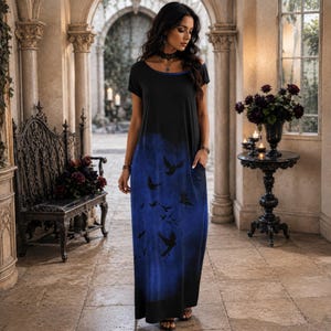 May include: A black maxi dress featuring short sleeves, a round neckline, and a blue gradient print at the bottom that transitions from black to deep blue. The lower portion of the dress is decorated with a pattern of black silhouettes of flying birds.