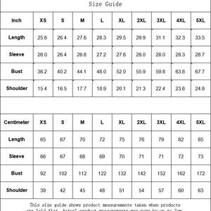 May include: A black and white size guide chart featuring two tables with measurements in inches and centimeters for sizes XS through 5XL. The chart lists length, sleeve, bust, and shoulder dimensions, with a disclaimer about flat measurements.