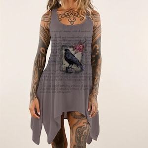 May include: A sleeveless grey tank dress featuring a printed graphic of a black raven perched on a book, accented by red roses. The fabric is overlaid with cursive text from Edgar Allan Poe's The Raven, including the phrase, This it is, and nothing more.