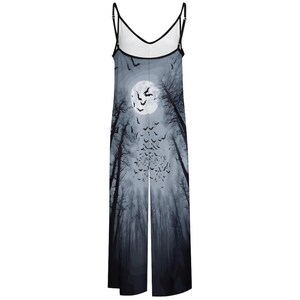 May include: A sleeveless jumpsuit featuring a full-length graphic print of a dark forest at night with a large white moon and a swarm of black bats. The garment has thin black spaghetti straps and a V-neckline with black trim along the edges.