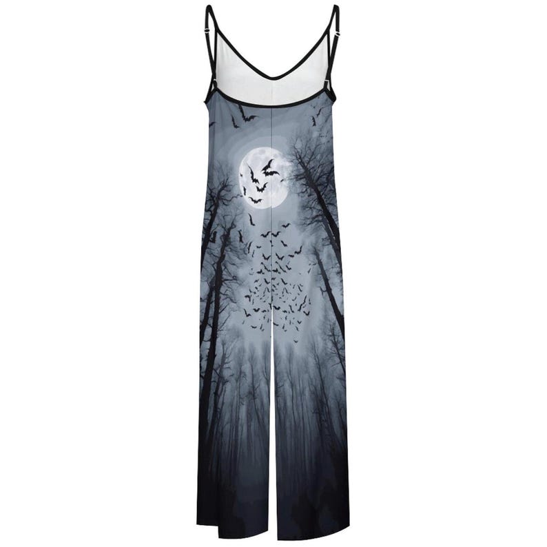 May include: A sleeveless jumpsuit featuring a full-length graphic print of a dark forest at night with a large white moon and a swarm of black bats. The garment has thin black spaghetti straps and a V-neckline with black trim along the edges.
