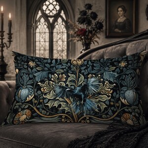 May include: A rectangular throw pillow featuring a dark, intricate botanical pattern with deep blue, green, and gold foliage. A central black crow with spread wings is depicted amidst the stylized leaves, flowers, and swirling vine motifs.