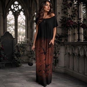 May include: A floor-length dress featuring a black bodice that transitions into a dark brown skirt with a printed pattern of flying birds and scattered red accents. The garment has short sleeves, a wide neckline, and side pockets.