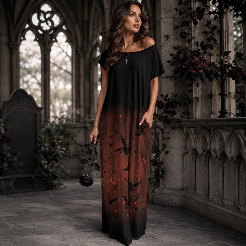 May include: A floor-length dress featuring a black bodice that transitions into a dark brown skirt with a printed pattern of flying birds and scattered red accents. The garment has short sleeves, a wide neckline, and side pockets.