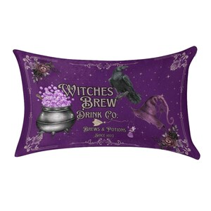 May include: A rectangular purple throw pillow featuring a black cauldron filled with bubbling purple liquid, a black raven, and a purple pointed hat. The text reads Witches Brew Drink Co. Brews & Potions Since 1692, surrounded by floral accents.