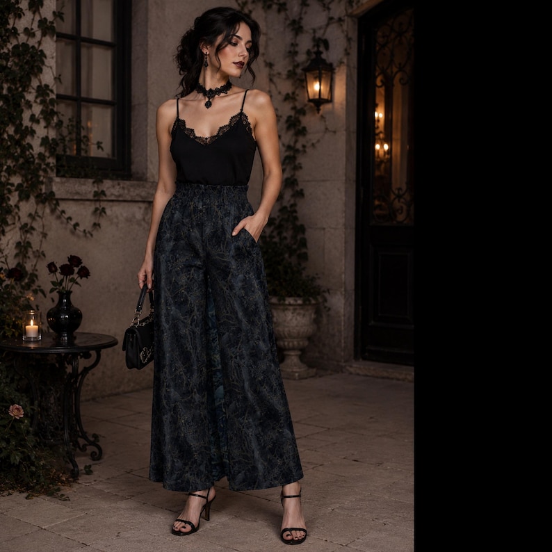 May include: A black camisole top with lace trim and thin straps paired with high-waisted, wide-leg trousers featuring a dark, intricate botanical pattern. The outfit includes a black handbag, a black choker necklace, and black heeled sandals.
