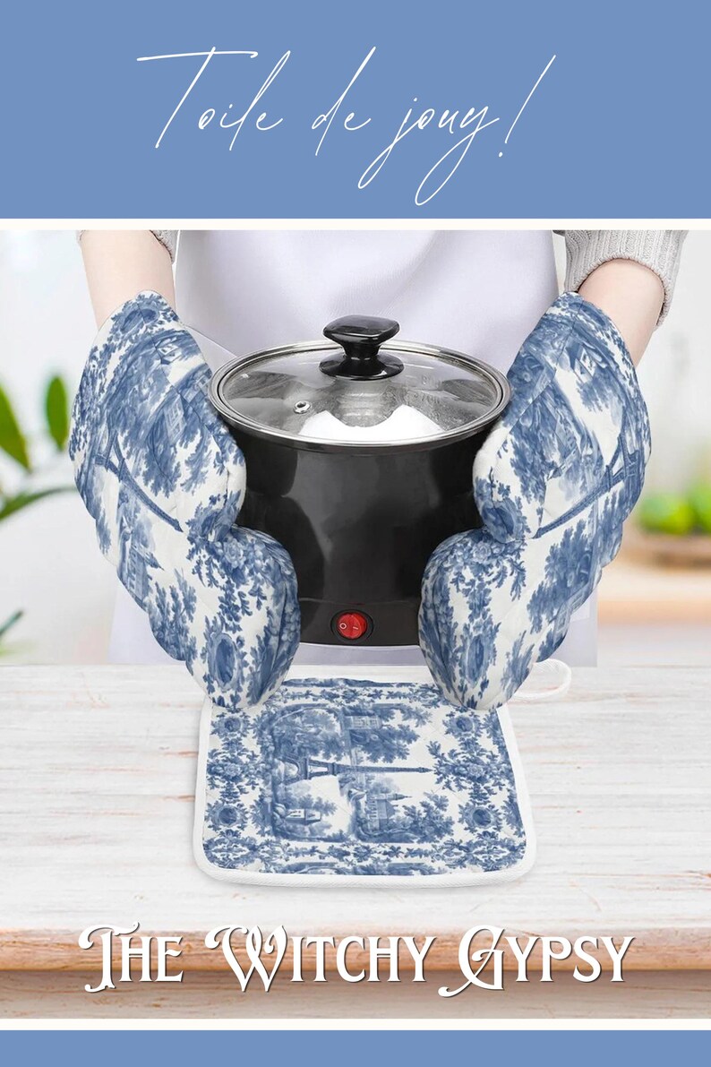 May include: A pair of oven mitts and a square pot holder featuring a blue and white toile de jouy pattern depicting landscape scenes. The mitts are shown holding a black electric pot with a glass lid and a red power switch on the front.