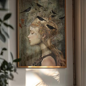 May include: A framed wall art print featuring a profile portrait of a person with long blonde hair intertwined with bare branches and autumn leaves. Several black birds are perched among the branches, set against a muted, textured background.