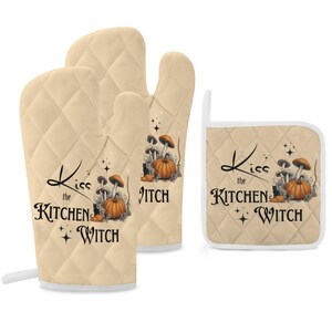 May include: Set of three beige quilted oven mitts with a black and orange print of mushrooms and pumpkins. The mitts have the text "Kiss the Kitchen Witch" printed on them.