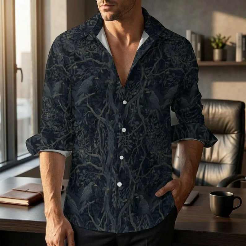 May include: A long-sleeve button-down shirt featuring a dark, moody pattern of silhouetted birds perched within dense, intertwining tree branches and foliage. The shirt has a classic collar, white buttons, and a white inner lining visible at the neck.