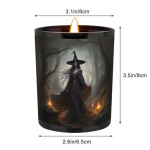 May include: A black candle featuring a witch illustration. The candle measures 9 cm high and 8 cm wide. The witch is depicted in a black dress and hat, set in a forest scene. The candle has a diameter of 6.5 cm.
