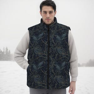 May include: A sleeveless puffer vest featuring a dark navy blue and black pattern of crows perched on tree branches. The vest has a high collar, a full-length front zipper, and is worn over a light beige long-sleeved sweater in a snowy setting.