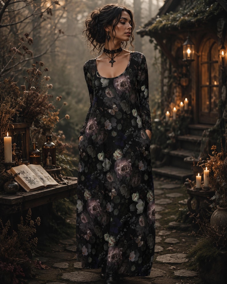 May include: A long-sleeved, floor-length dress featuring a dark black base with a repeating floral pattern in shades of muted purple, grey, and soft green. The garment has a rounded scoop neckline and integrated side pockets for a functional design.