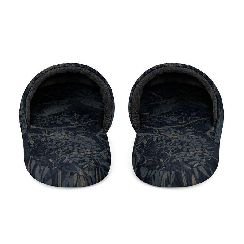 May include: A pair of slip-on slippers featuring a dark navy blue and charcoal gray botanical pattern with intricate illustrations of branches, leaves, and berries. The interior lining is a solid dark gray, and the rounded toe design provides a wide opening for easy entry, showcasing a consistent dark color palette throughout the fabric.