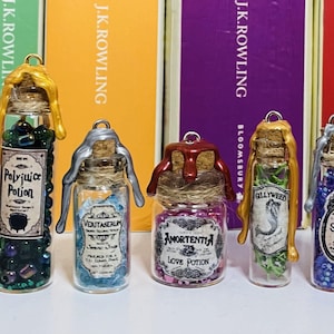 May include: Eight small glass bottles with cork stoppers and various colored beads inside. Each bottle has a label with a different potion name, including "Polyjuice Potion", "Amortentia Love Potion", and "Drought of Living Death". The bottles are arranged in a row on a table with a bookshelf in the background.