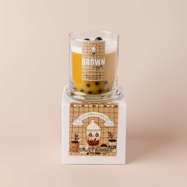 May include: A brown sugar scented candle in a glass jar with a brown sugar boba tea design. The candle is on a white box with the text "I Love Boba Candles" and "Brown Sugar" printed on it.